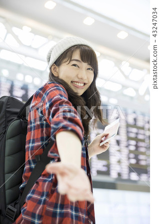 Back parker women reaching out at the airport 43247034