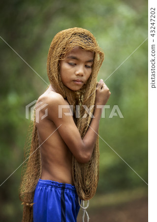 The image of a young man using a fishing net The image of a young man using a fishing net 43247202