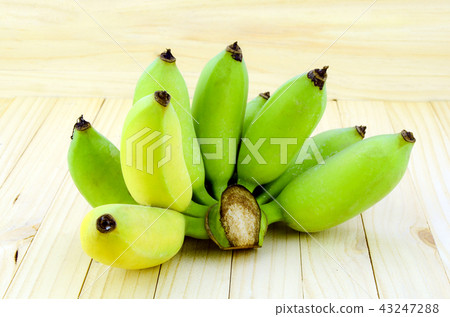 Organic Asian Banana on pine wood background. Organic Asian Banana on pine wood background. 43247288