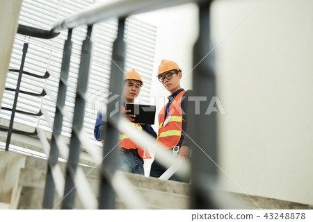 Construction engineers discussing work 43248878