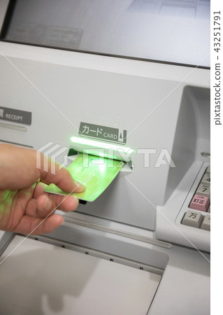Male hand to put a cash card in ATM Male hand to put a cash card in ATM 43251791