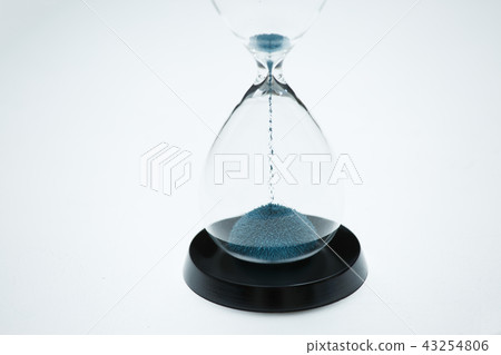Image of hourglass with blue sand on isolated white background Image of hourglass with blue sand on isolated white background 43254806