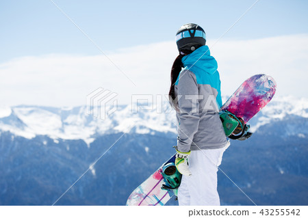 Photo from back of woman tourist helmet with snowboard on background of snowy mountains 43255542