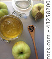 flat lay honey apple and spoon on light background 43258200