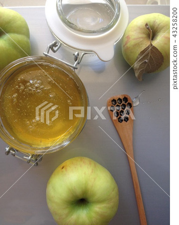 flat lay honey apple and spoon on light background flat lay honey apple and spoon on light background 43258200