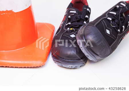 work shoes and a safety cone work shoes and a safety cone 43258626