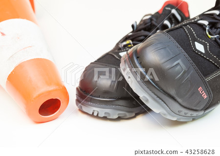 work shoes and a safety cone work shoes and a safety cone 43258628