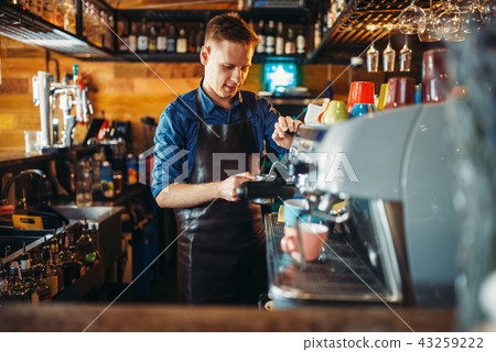 Male bartender prepares drink at the bar counter 43259222