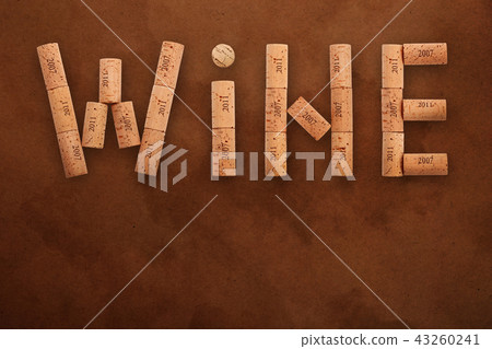 Word wine shaped by corks on brown paper parchment 43260241