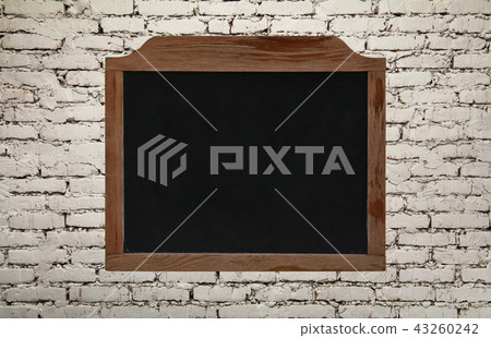 Old vintage black chalkboard on brick wall 43260242