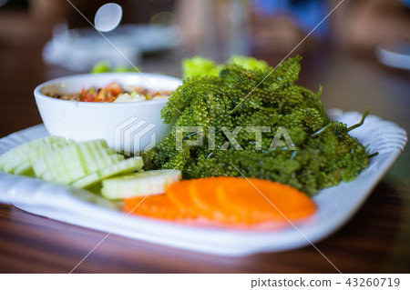 Thai spicy papaya salad with seaweed caviar Thai spicy papaya salad with seaweed caviar 43260719