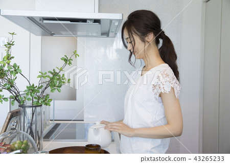 A woman who is making tea A woman who is making tea 43265233