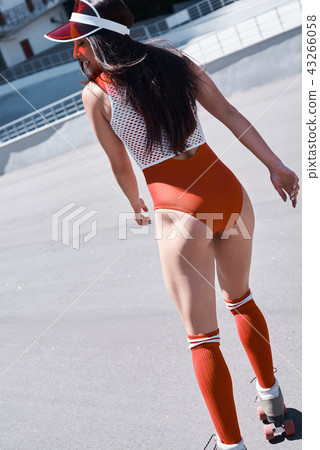 Beautiful girl is riding in rollers in skate park. She is doing that very active. She is happy. Beautiful girl is riding in rollers in skate park. She is doing that very active. She is happy. 43266058
