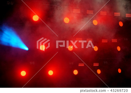 Several red stage lights in the dark 43269720