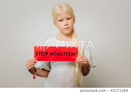 Serious girl holding a table with a slogan 43271269