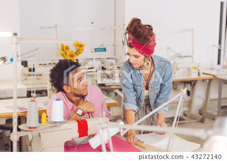 Strict atelier owner looking at the tailor while standing next to him 43272140