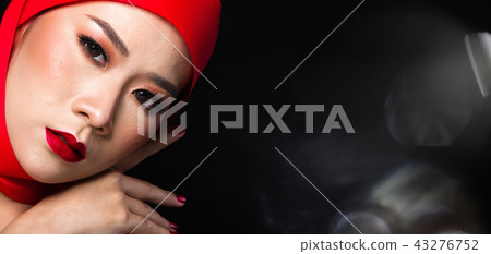Asian tanned skin woman with strong color red lips Asian tanned skin woman with strong color red lips 43276752