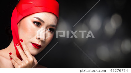 Asian tanned skin woman with strong color red lips 43276754