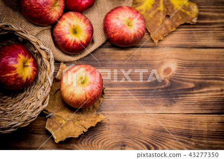 Fall harvest cornucopia. Basket with red apples Fall harvest cornucopia. Basket with red apples 43277350