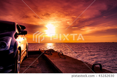 Blue SUV car parked on concrete road by the sea  43282630