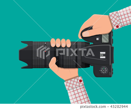 Modern photo camera in hand. 43282944