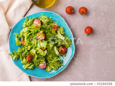 Salad with cherry tomatoes on blue plate Salad with cherry tomatoes on blue plate 43284298