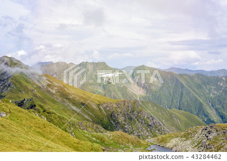 Drone flying in Fagaras Mountains Drone flying in Fagaras Mountains 43284462