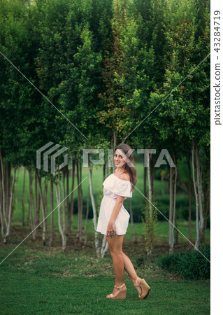 young and pretty girl in a summer city standing near the tree young and pretty girl in a summer city standing near the tree 43284719
