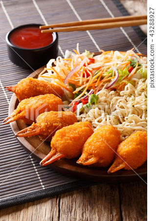Deep fried crab claws in a breading, udon noodles 43288927