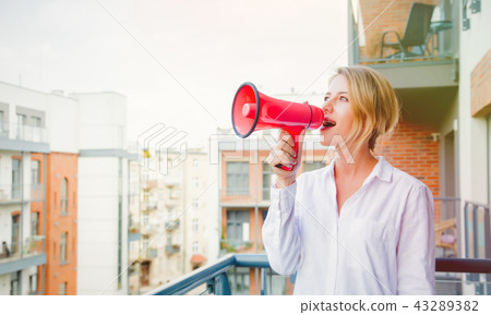 girl with loudspeaker talking abount something 43289382