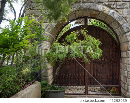 Stone wall with an old door Stone wall with an old door 43292989