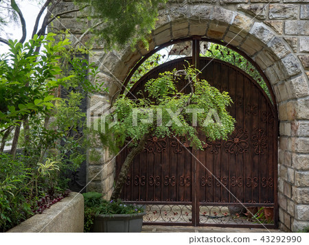 Stone wall with an old door Stone wall with an old door 43292990