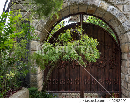 Stone wall with an old door Stone wall with an old door 43292991