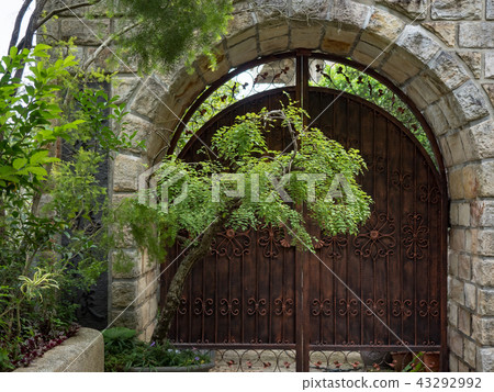 Stone wall with an old door Stone wall with an old door 43292992