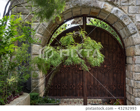 Stone wall with an old door Stone wall with an old door 43292993