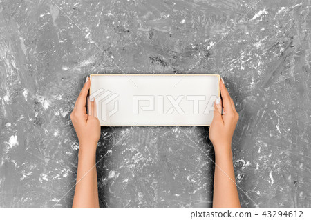 Woman hands holding empty orange box Woman hands holding empty orange box 43294612