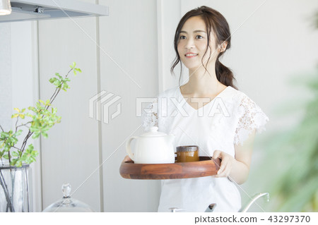 A woman who is making tea A woman who is making tea 43297370