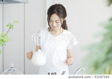A woman who is making tea A woman who is making tea 43297384