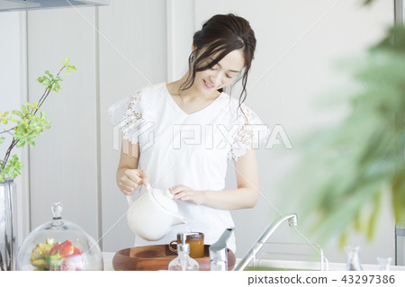 A woman who is making tea A woman who is making tea 43297386