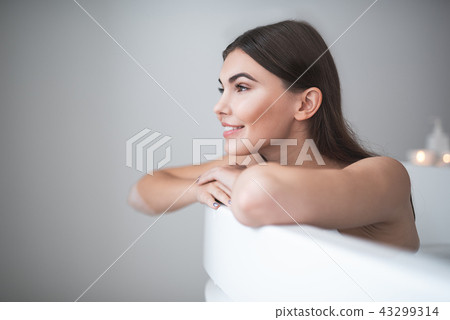 Cheerful girl having leisure in cozy bathroom 43299314