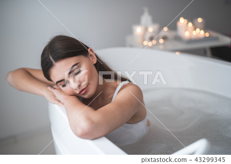 Orderly girl lying in water during treatment Orderly girl lying in water during treatment 43299345