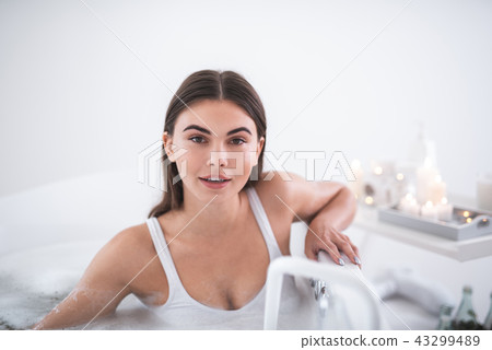 Optimistic girl resting in bath in room Optimistic girl resting in bath in room 43299489