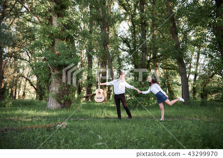 young couple walking in the forest, romantic young couple walking in the forest, romantic 43299970