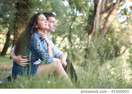 young couple walking in the forest, romantic  43300003