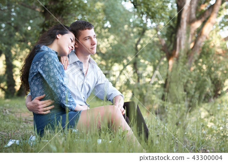 young couple walking in the forest, romantic young couple walking in the forest, romantic 43300004