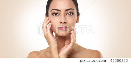 Beautiful indian girl with perfect skin touching face Beautiful indian girl with perfect skin touching face 43300233