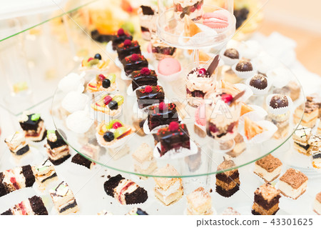 Different kinds of baked sweets on a buffet Different kinds of baked sweets on a buffet 43301625