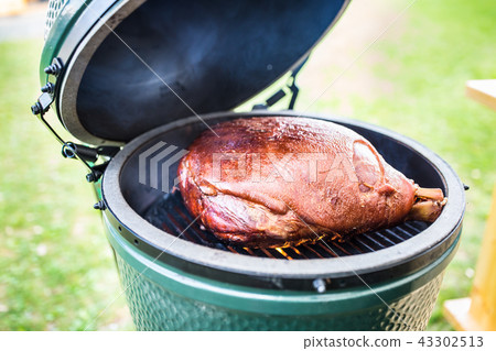 Grilled and smoked pork meat on professional grill 43302513