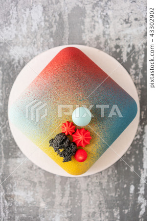 Elegance square velour mousse cake. nut and fruit filling inside. Contemporary colorful pie Elegance square velour mousse cake. nut and fruit filling inside. Contemporary colorful pie 43302902