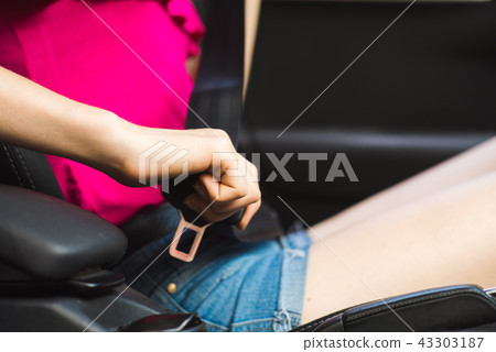 Female hand in car with seat belt 43303187
